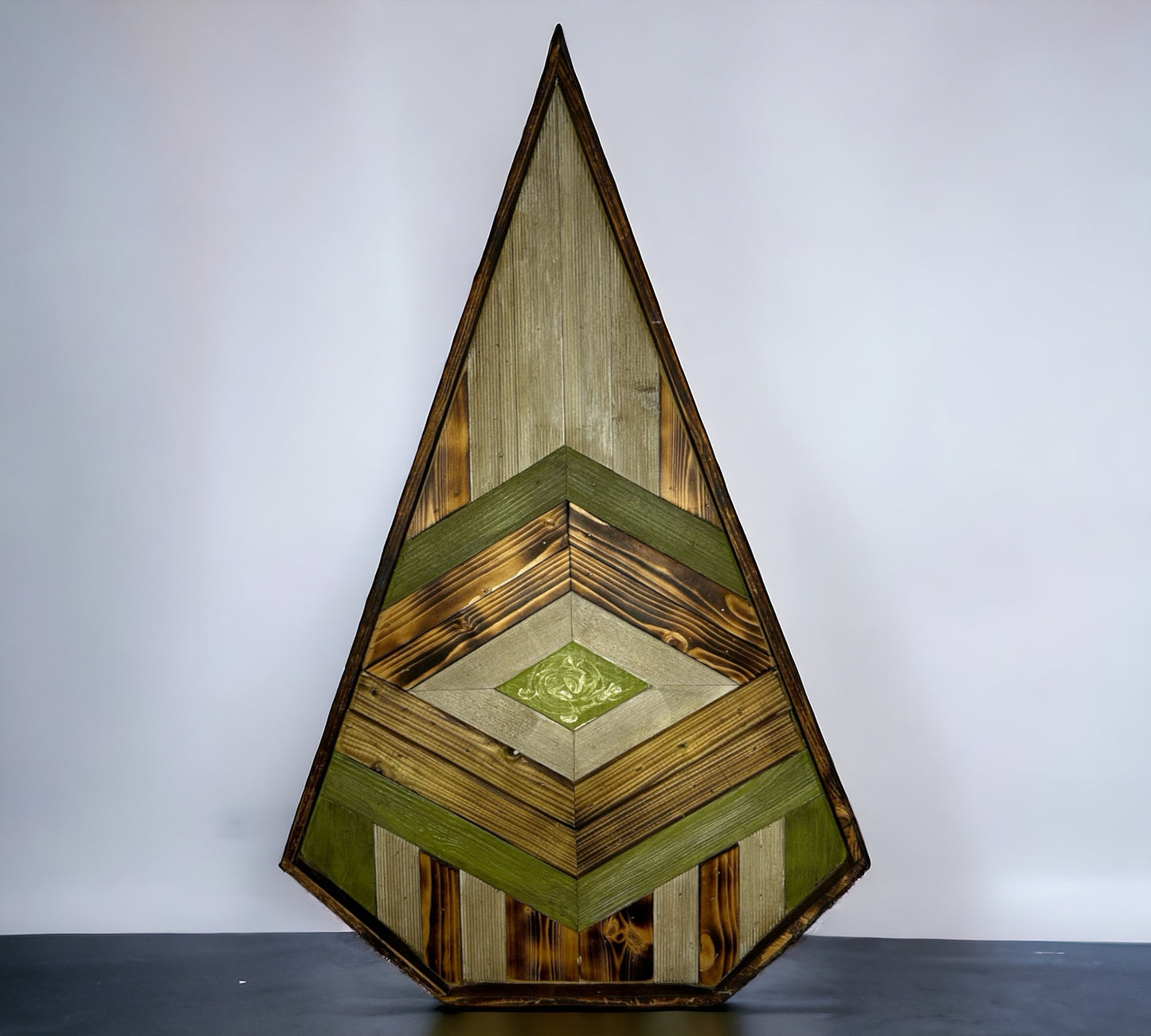 A Patterned Pointed Dynamic Green Piece of Reclaimed Wood Wall Art.